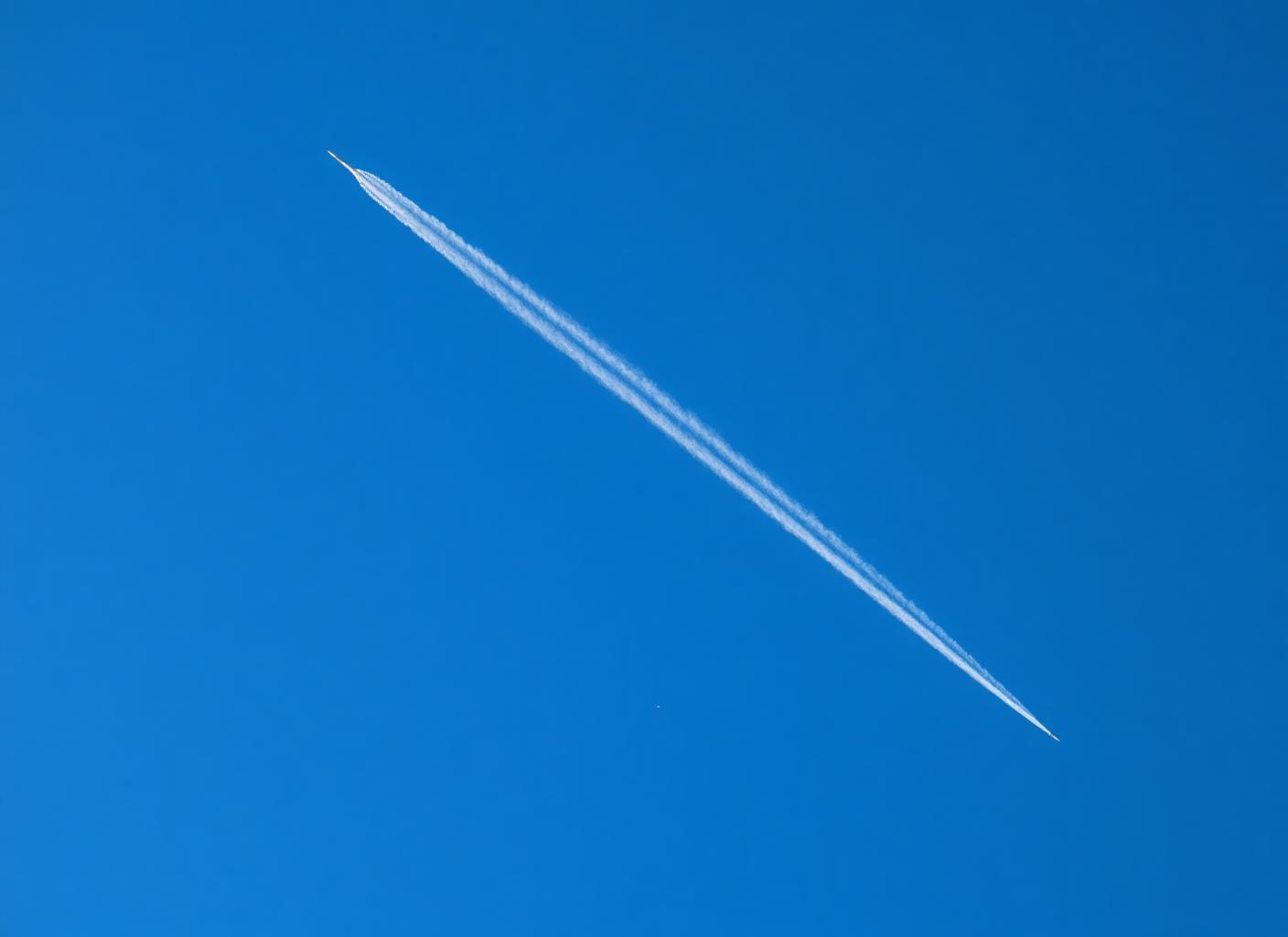 Jet contrails across a clear blue sky