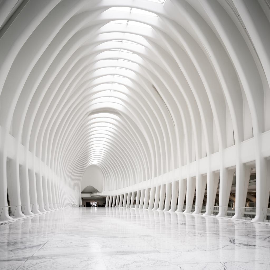 White curved architectural corridor with marble floor